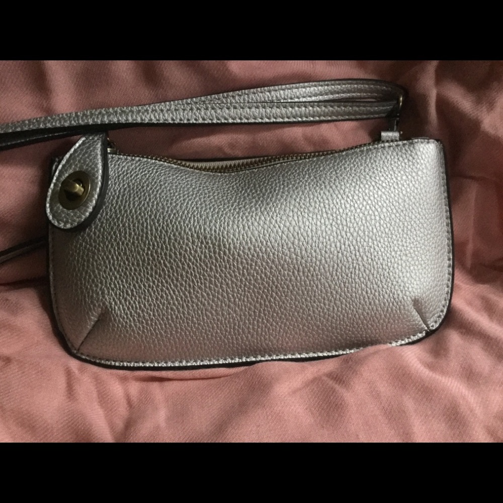 Vegan leather bag. Size: 5″ high X 7.5″ wide,.